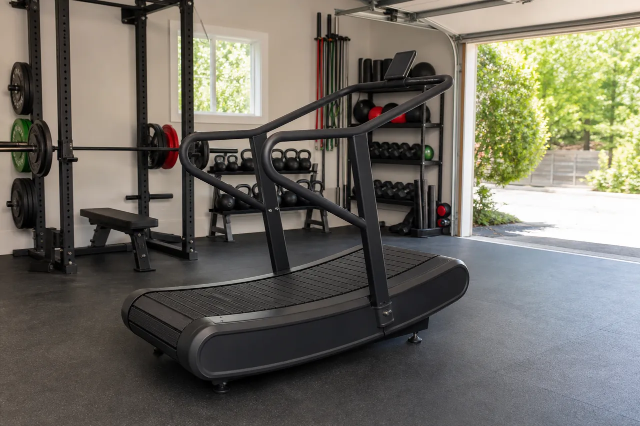 Generic unbranded curved manual treadmill on a rubber garage-gym floor