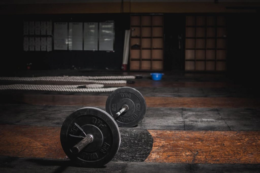 empty garage gym - barbell on floor