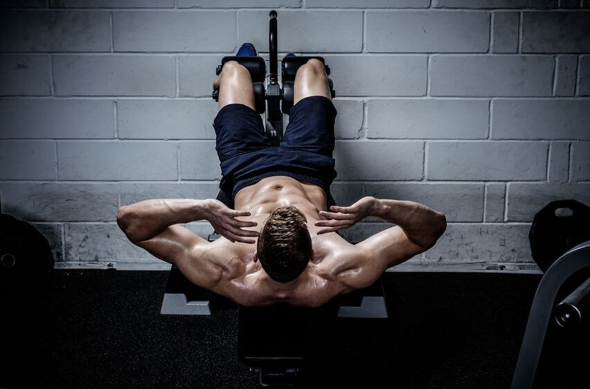 Muscular man doing exercises for abdominal in The Gym