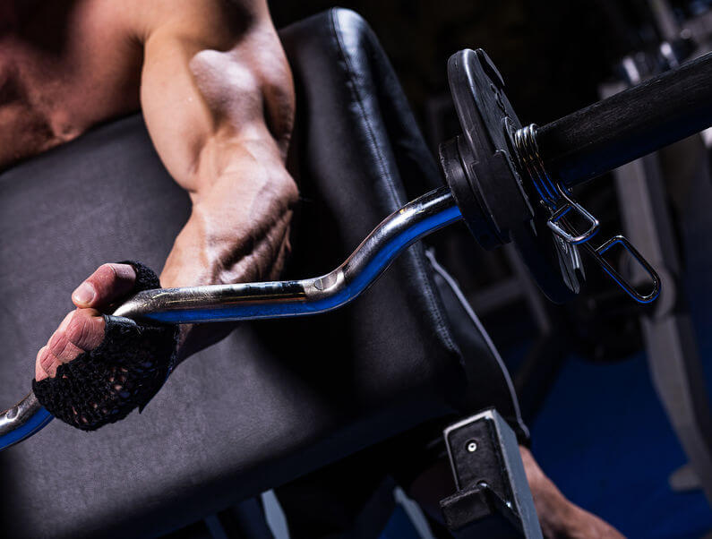 man during preacher curl exercise