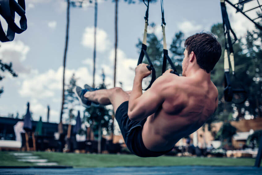 man training outdoor on TRX suspension trainer