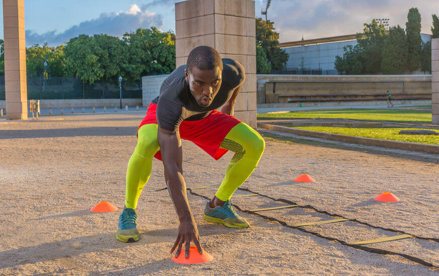 man doing speed training with agility ladders