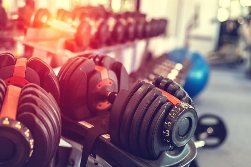 close up dumbbells set in rack