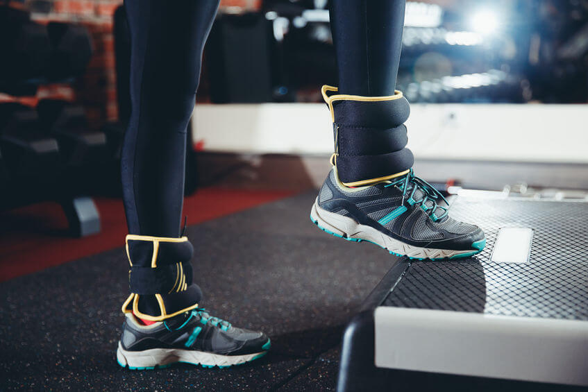 girl in gym with weights on her ankle