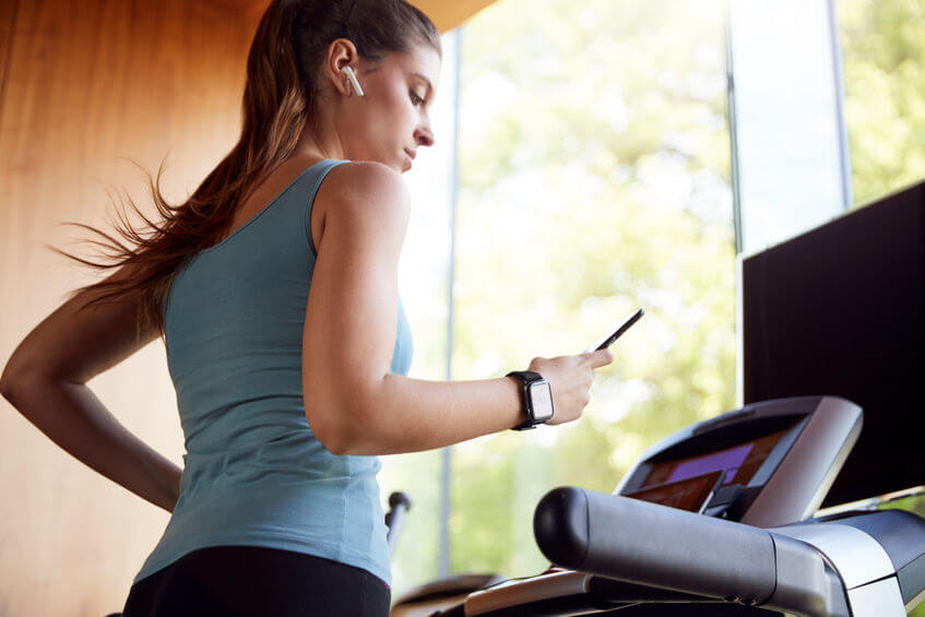 woman exercising on treadmill at home