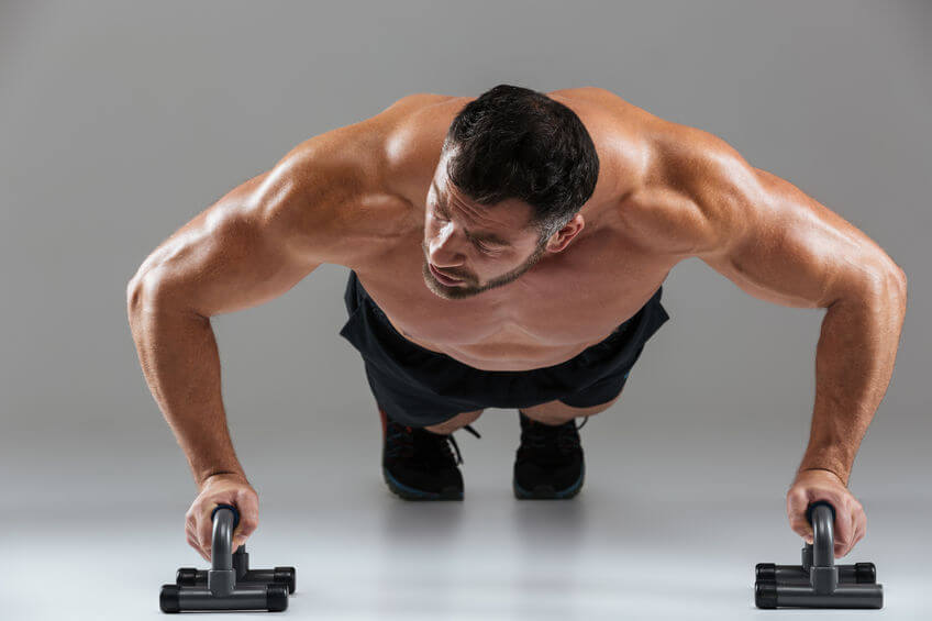 bodybuilder doing push-ups with bars