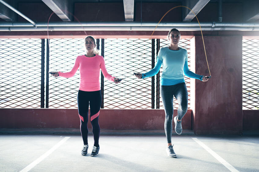 athletic girls doing jump rope exercise