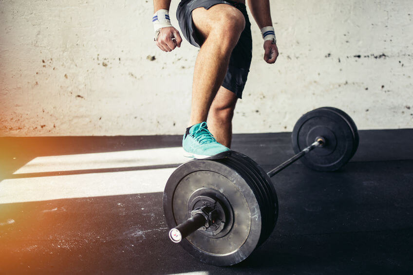 man preparing for barbell training in gym