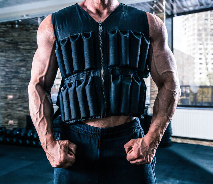 man wearing in weighted vest in gym