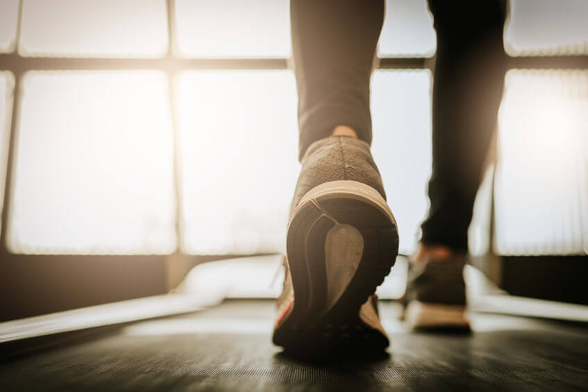 Close up shot of woman leg running on a incline treadmill