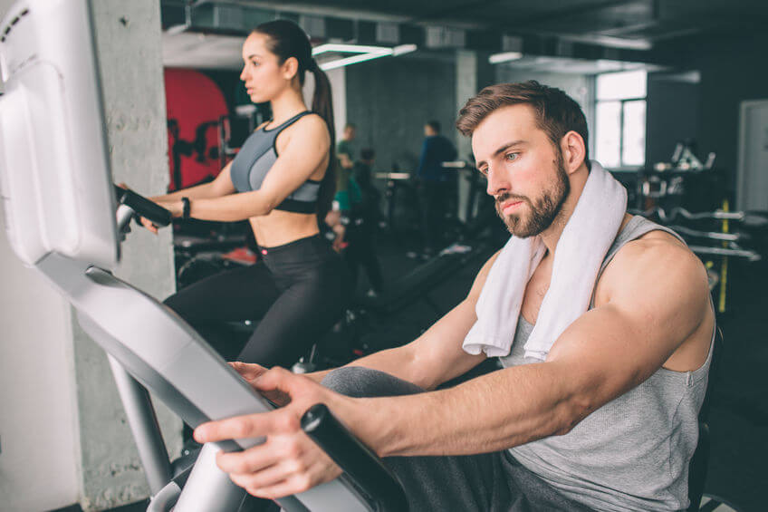 close up of young man training on the recumbent bike