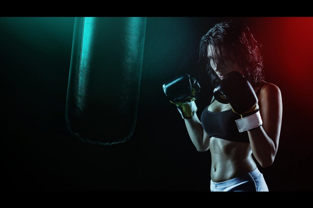 girl boxing workout with heavy bag