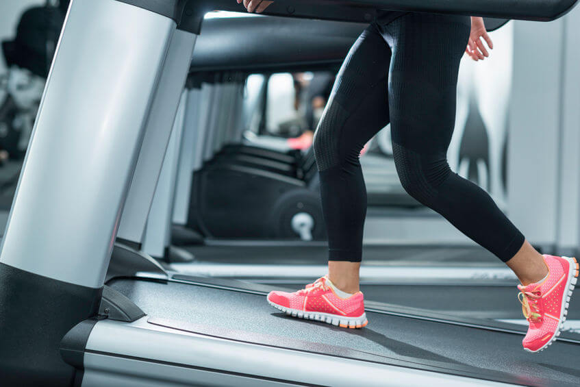 woman using incline treadmill in the gym