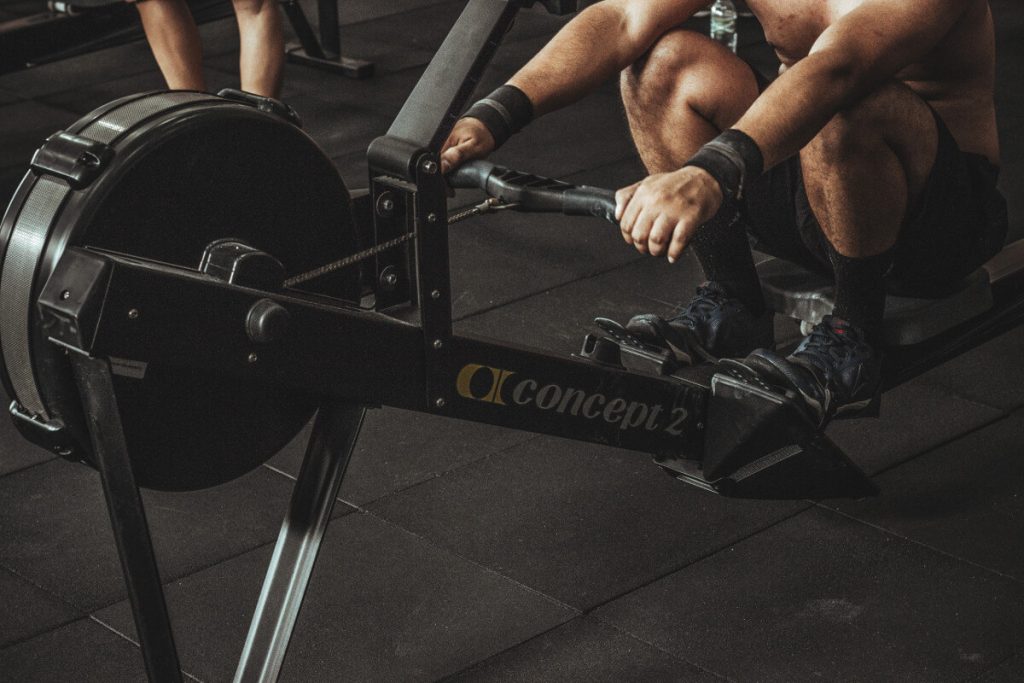 man using rowing machine