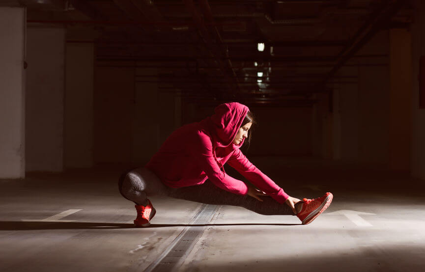 woman doing warm up exercise before running