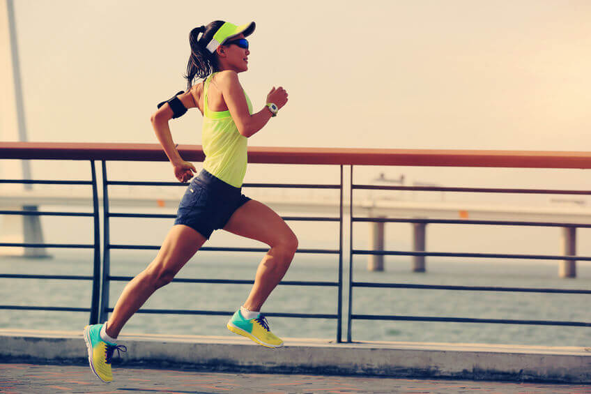 young fitness woman runner running at seaside