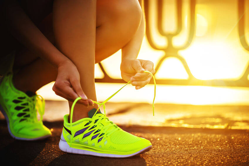 female runner with barefoot running shoes closeup