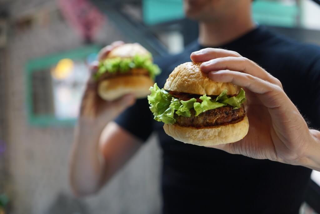 man holding two hamburgers