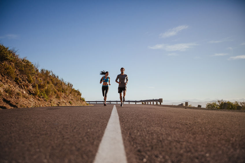 people running on hill by road