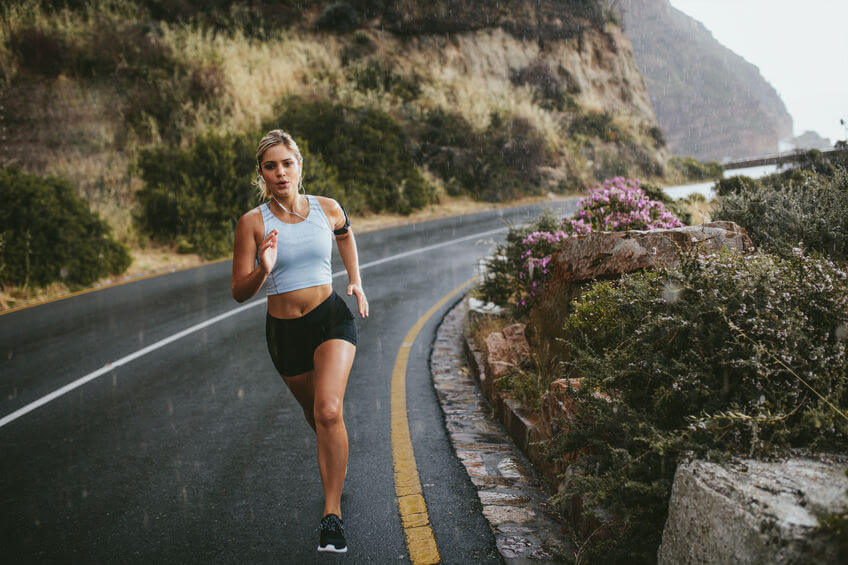 woman running outdoors during rain