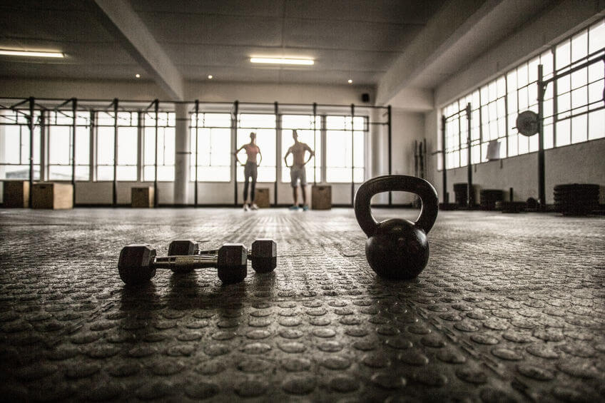 two fit people on the background in crossfit gym