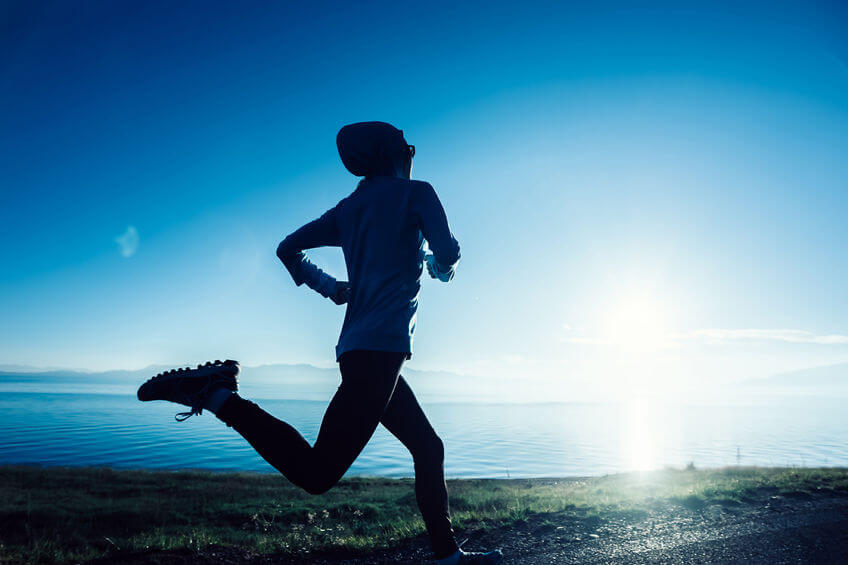 fitness woman running on country road