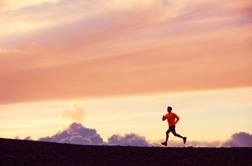 man running into sunset