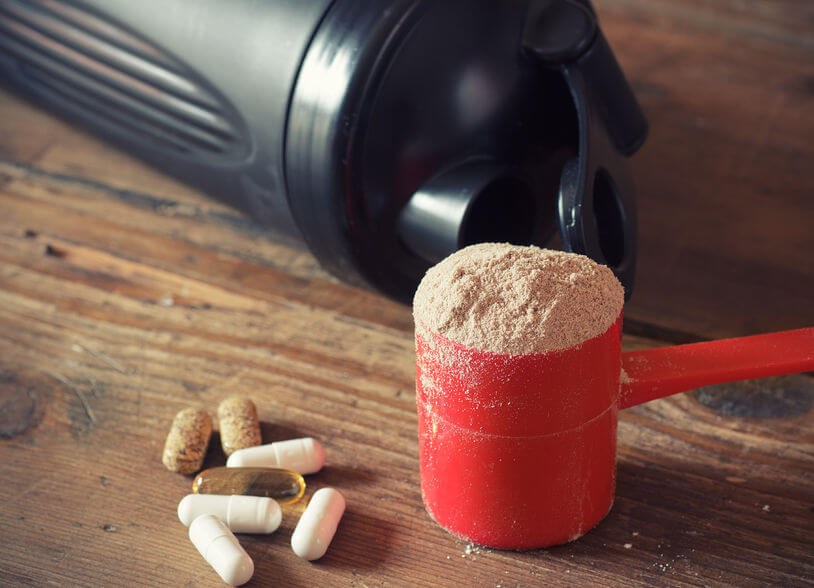 protein powder in scoop with vitamins