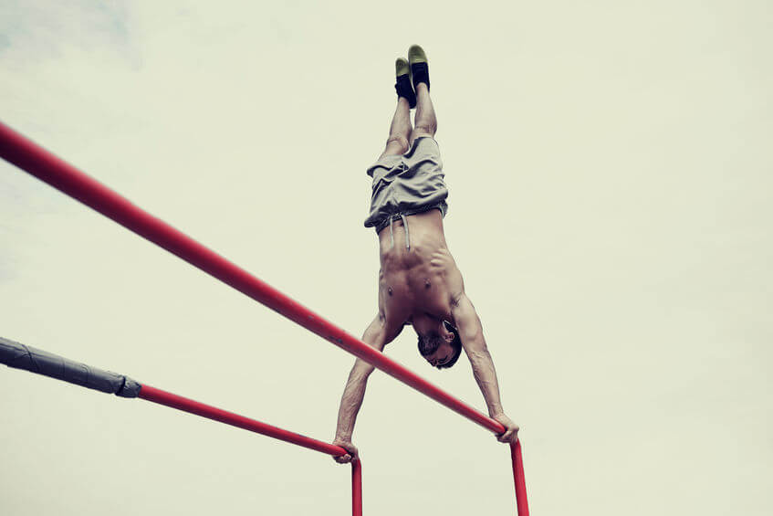 calisthenics training - man exercising on parallel bars