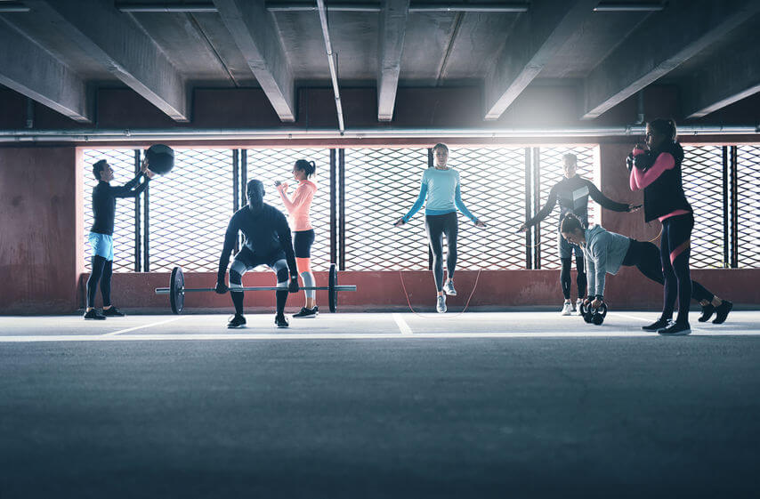 group of people exercising together in CrossFit gym