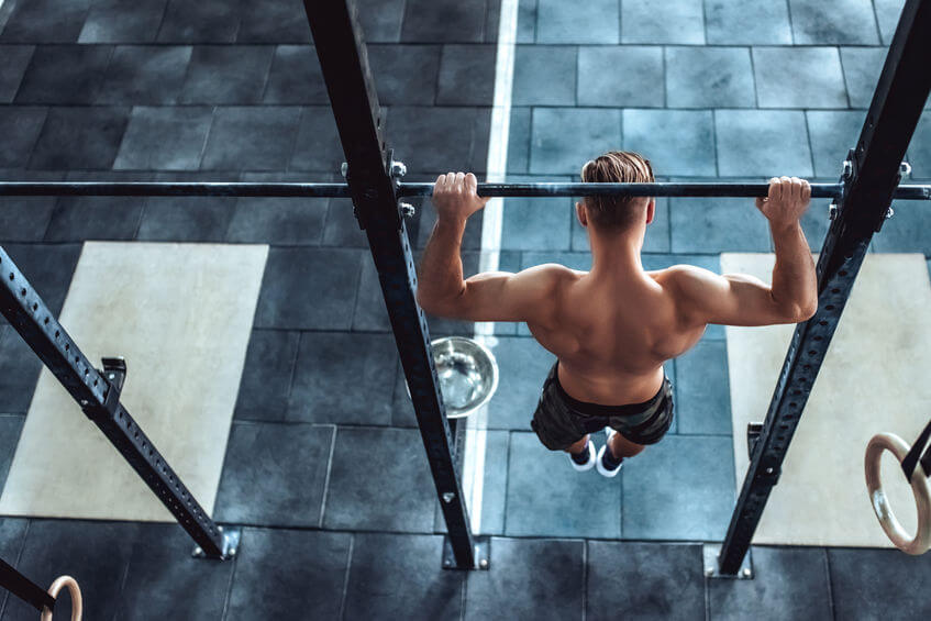 man is working out in CrossFit gym