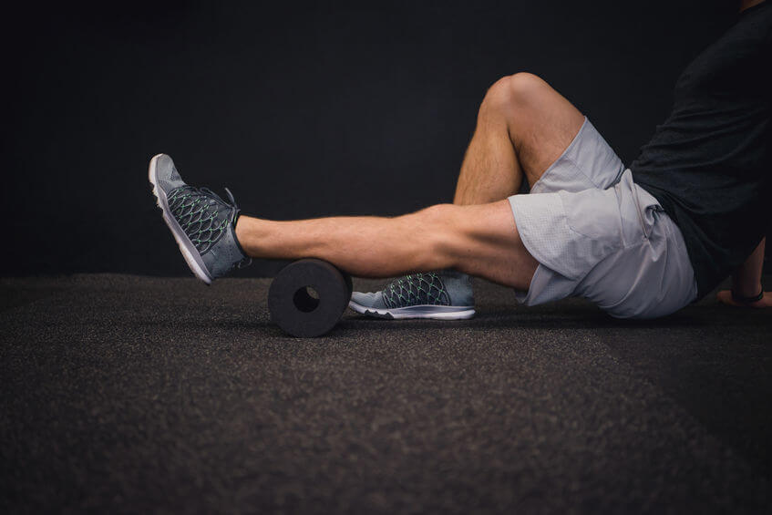 man using a foam roller