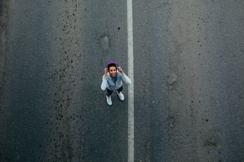 running women putting on headphones