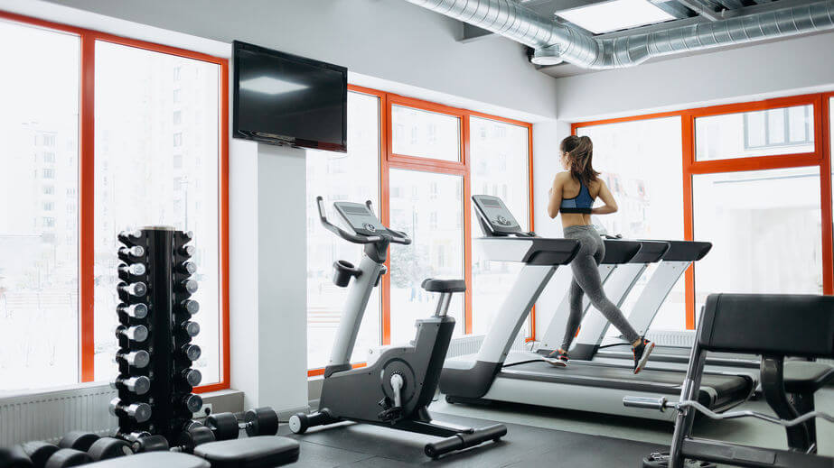 woman doing exercises on the treadmill