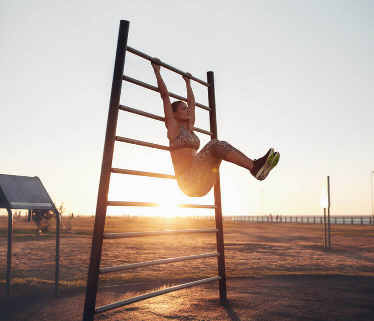 woman exercising on wall bars