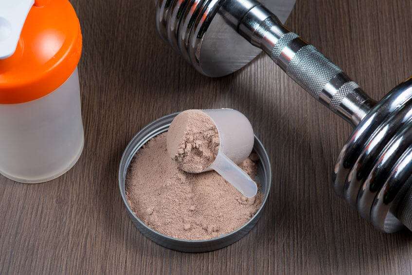 Whey protein with a metal dumbbell and shaker