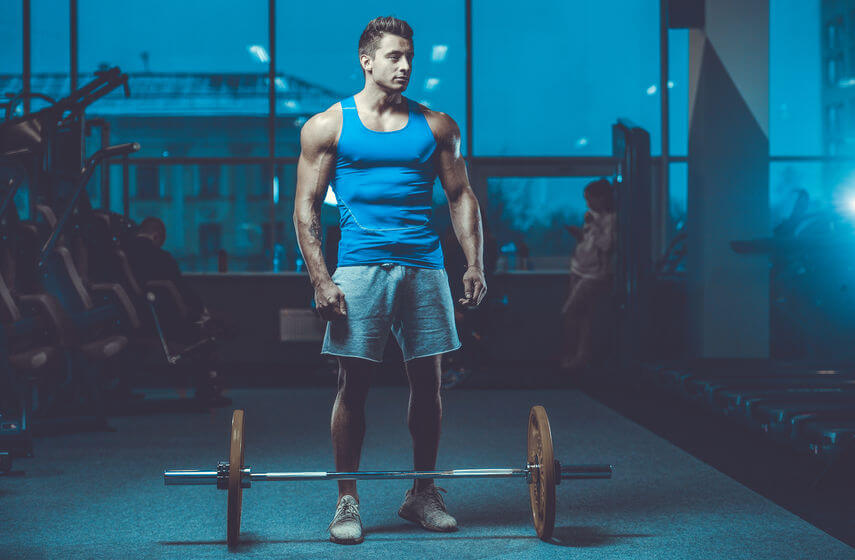 bodybuilder with barbell in gym