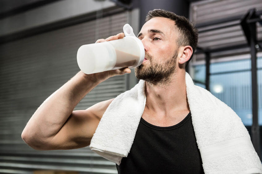 man drinking protein shake at the crossfit gym