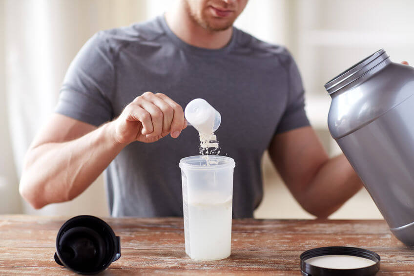 man preparing whey protein shake