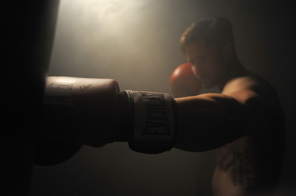 punching heavy bag with boxing gloves