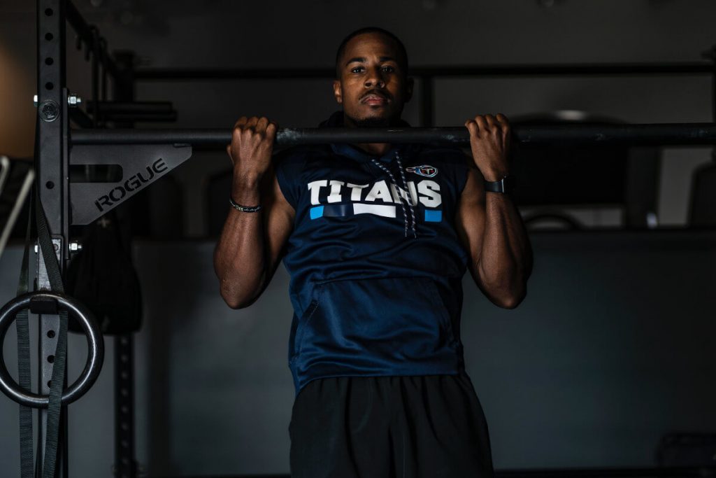 man lifting up gym equipment