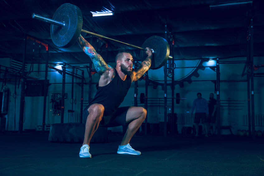 man doing exercise with the barbell in the gym