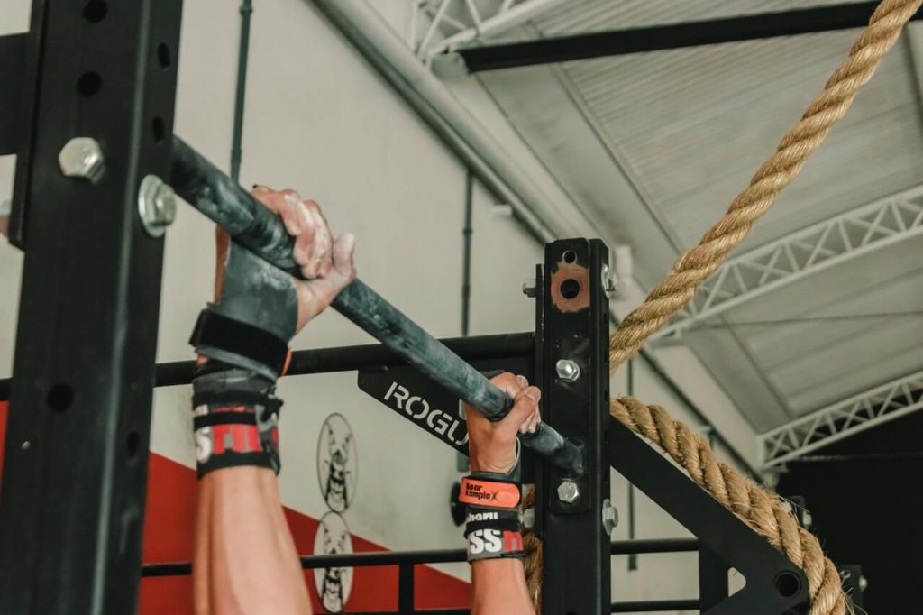 person doing pull up exercise in CrossFit gym