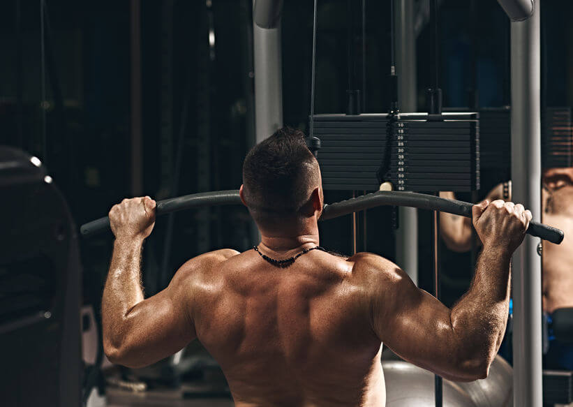 man doing lat pulldown exercise at the gym