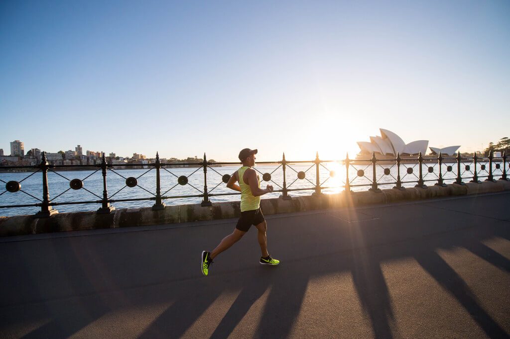 man running on bay walk during daytime