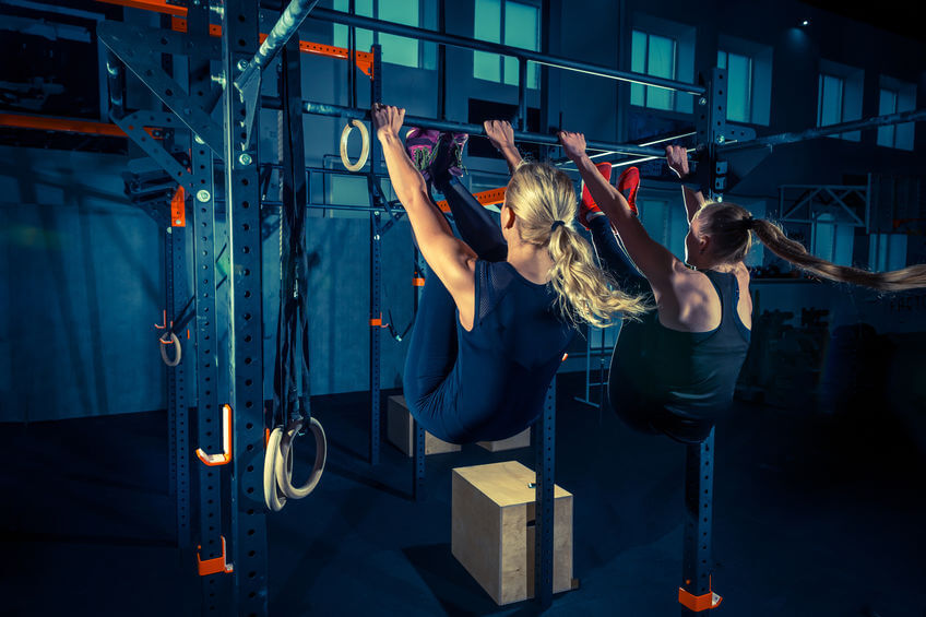 two women doing workout at CrossFit gym