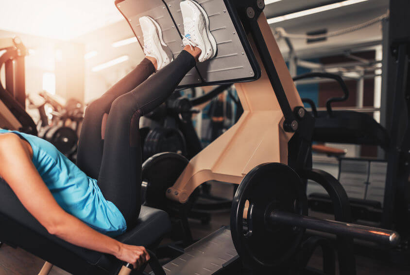 woman exercise on leg press at the gym