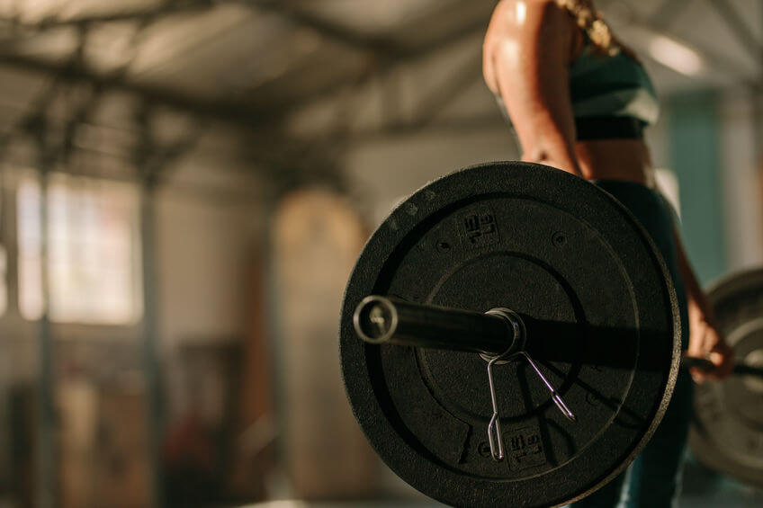 woman exercising with heavy weights