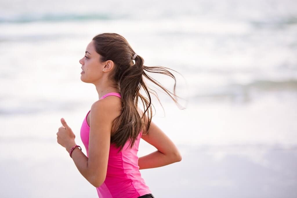 woman slowly jogging on the beach