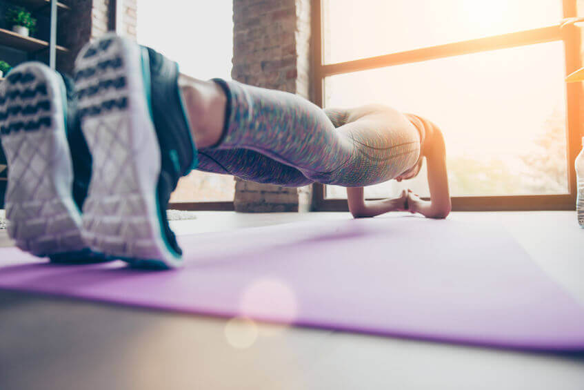 close up photo of woman holding plank position